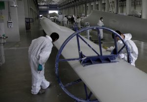 Workers examine wind turbine blades at a Vestas Wind Technology factory in Tianjin, 2010. AP Photo/Ng Han Guan, File 